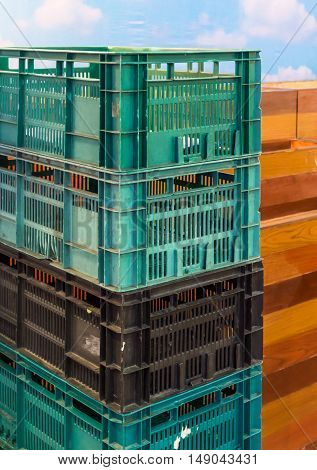 Pastic crate stack near the billboard in the fruit market.