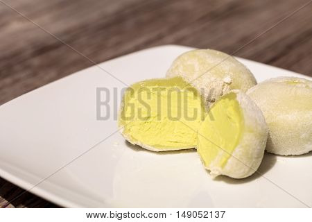 Green tea mochi ice cream bonbon desert on a white plate