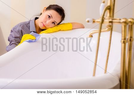 Young beautiful asian woman housekeeping in the bathroom