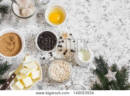 Christmas baking background. Flour sugar butter rolled oats eggs chocolate chips on a light background. Baking ingredients