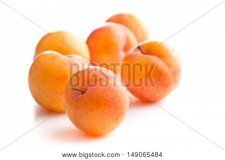Ripe yellow plums isolated on white background.