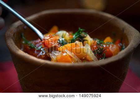 Hungarian national dish - bogracs close up in bread plate. Soft focus