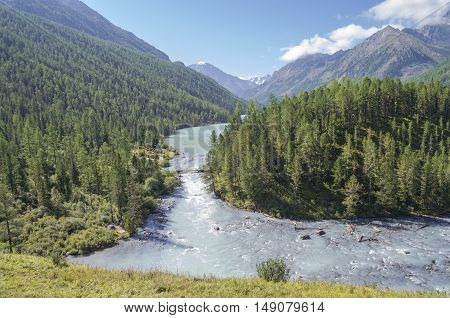 The Kucherla river flows from Kucherla lake. Altai Mountains Russia. Sunny summer day.
