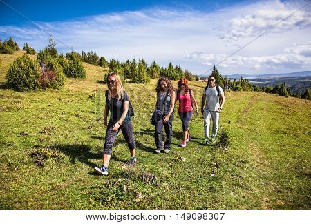 UVAC, SERBIA-SEP 17, 2016: Group of people with backpacks hiking at meanders of the river Uvac on Sep 17, 2016, southwest Serbia.