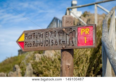Wooden road sigh pointing Pico Ruivo at the highest walking path of Madeira island.