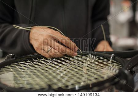 Close Up Of Tennis Stringer Hands Doing Racket Stringing