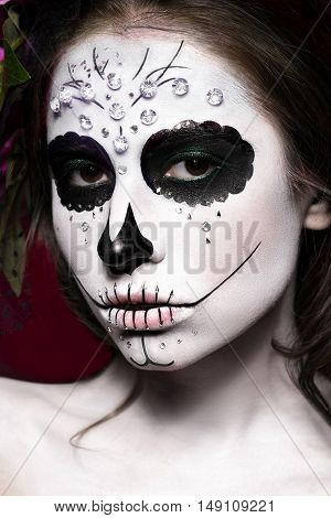 Woman in Halloween makeup - mexican Santa Muerte mask. Photos shot in studio