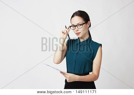 business woman with glasses and documents in hand