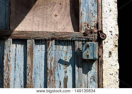 Old padlock on a wooden door texture