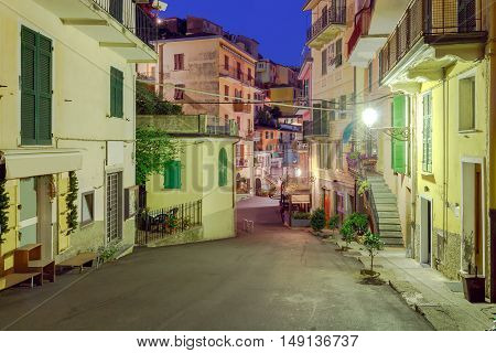 The old narrow street in the medieval Italian village of Manarola at night. Parco Nazionale delle Cinque Terre Liguria Italy.
