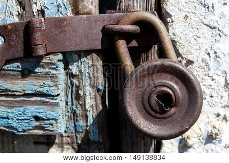 Old padlock on a wooden door texture