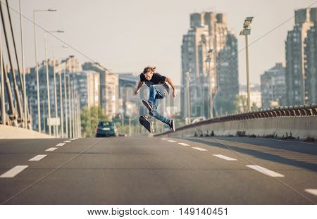 Skater Doing Tricks And Jumping On The Street Highway Bridge. Free Riding Skateboard