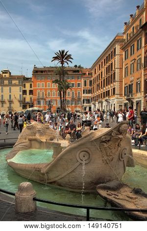 ROME ITALY - APRIL 7 2016: Piazza di Spagna - popular meeting places in Rome. Fontana della Barcaccia - elegant looking fountain commissioned by pope Urban VIII designed by Gian Lorenzo Bernini.