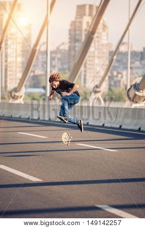 Skater Doing Tricks And Jumping On The Street Highway Bridge. Free Riding Skateboard