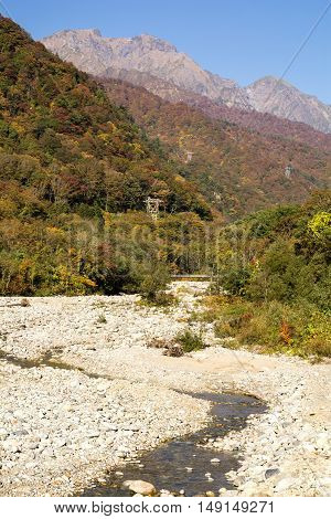 Autumn Yubiso river and Mount Tanigawa under blue sky