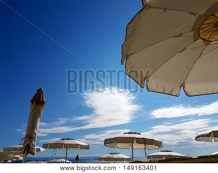Summer backgrounds of beautiful beaches with sand and umbrellas by the sea