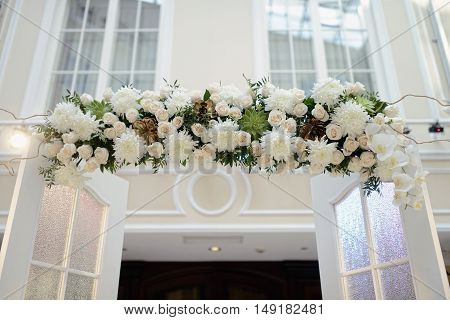 Beautiful Wedding Arch For Marriage Decorated With Lace Fabric And Flowers. White Decor For Bride An