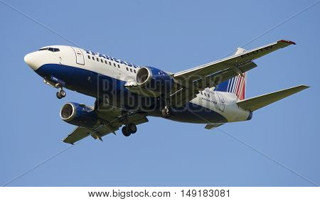 SAINT PETERSBURG, RUSSIA - JULY 24, 2015: Boeing 737-5Y0 (EI-DTW) of the company Transaero in flight closeup