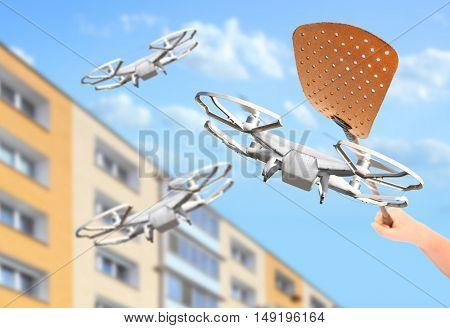 No fly zone. A swatter smashing drones. Rules for UAV traffic. Modern technologies over your head. Digital artwork with fictive copter.