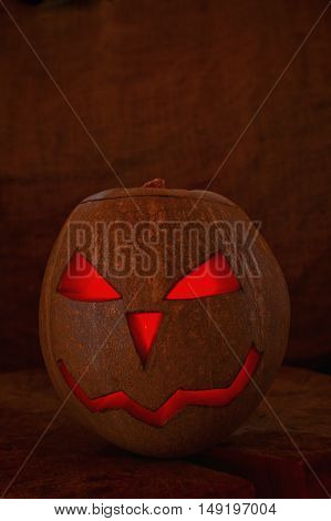 Scary face of halloween pumpkin isolated on dark background.