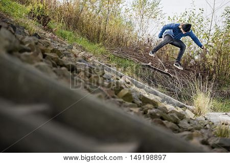 Boy doing skateboard trick kickflip on bank