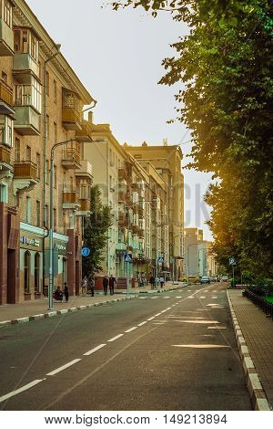 BELGOROD RUSSIA - SEPTEMBER 10 2016: Roadway Holy Trinity Boulevard in the center of Belgorod in the light of the low sun. Houses late Stalin era (mid 20th century) and modern buildings.