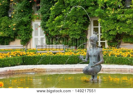 Salzburg Austria - September 3 2016: Fountain with a statue of a woman in Mirabell gardens. It is a very popular touristic place.
