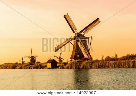 Windmills of Kinderdijk near Rotterdam in Netherlands. Colorful spring scene in the famous Kinderdijk canals with windmills, UNESCO world heritage site