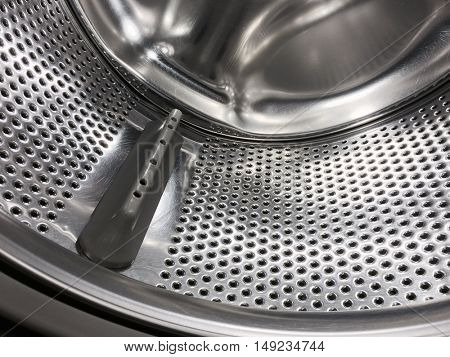 Washing machine drum, perforated metallic background