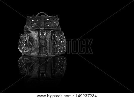 chic luxury leather black bag with clip lock diamond studs and dual small bag zipper for women on black background and reflection shadow isolated included clipping path