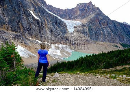 Woman relaxing on mountain top. Candian Rockies. Alberta. Canada.