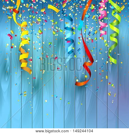 Colorful confetti and streamers on wooden background