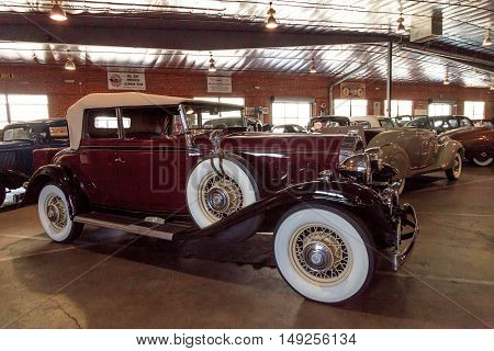 El Segundo, CA, USA - September 26, 2016: Maroon and black 1932 Buick convertible with a white soft top displayed at the Automobile Driving Museum in El Segundo, California, United States. Editorial use only.