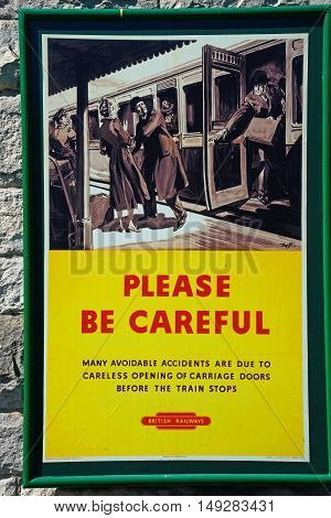 CORFE, UNITED KINGDOM - JULY 19, 2016 - Old fashioned British Railways Be Careful poster at the railway station Corfe Dorset England UK Western Europe, July 19, 2016.