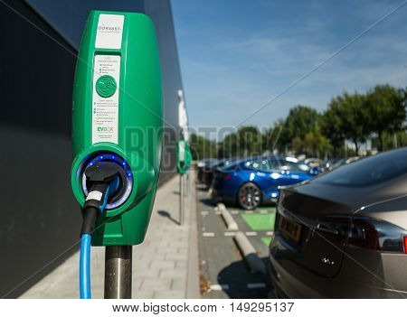 TILBURG, NETHERLANDS - SEPTEMBER 25, 2016: Electric vehicle charging station in  Tesla Supercharger Station of Tilburg, Netherlands.