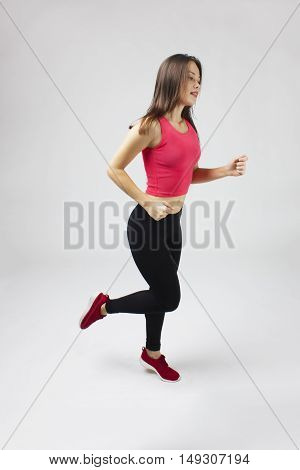 Runner woman. Running fit fitness sport model smiling happy isolated on white background.