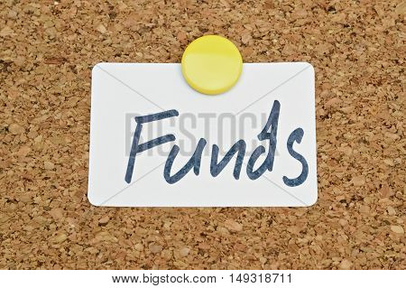 Word Funds written on a sticker pinned on a cork board