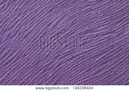Purple background from a soft wool textile material closeup. Fabric with natural texture. Cloth backdrop.