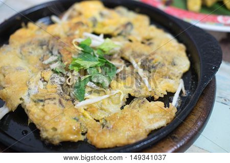 Oysters fried in egg batter on iron pan (cooking) - Thailand food Pan - fried crispy mussel with bean sprout Crisp fried oyster pancake