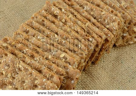 Multi grain whole grain crispbread crackers on burlap