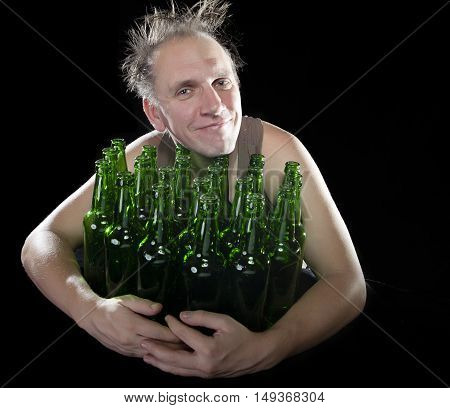 The happy tipsy man near empty beer bottles