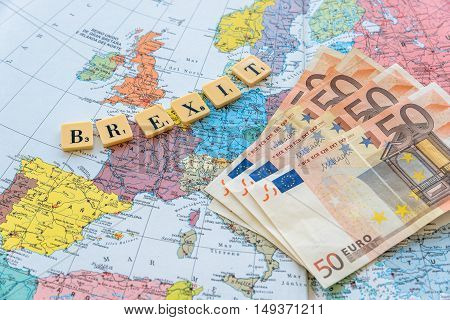 London UK - June 12 2016: Brexit word with euro money on european map. The United Kingdom European Union membership referendum on 23 June 2016