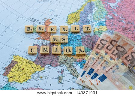 London UK - June 12 2016: Brexit vs Union words on european map with euro money. The United Kingdom European Union membership referendum on 23 June 2016