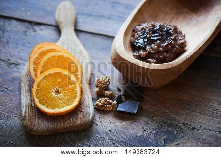 Delicious rice porridge with chocolate and nuts in a wooden bowl