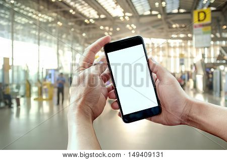 Smart phone showing blank screen in man hand at Check in Counter and Passengers in a airport departure terminal.