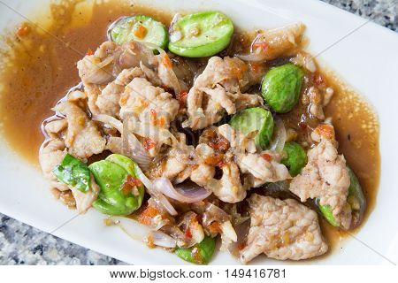 Thai food style. stir fried pork parkia with shrimp paste Pad Sator Moo Kapi.