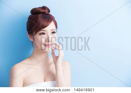 beauty woman look somewhere isolated on blue background asian