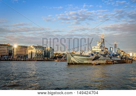 LONDON UK - AUGUST 21 2015: London cityscape at sunset. View from City Hall with warship on the foregound