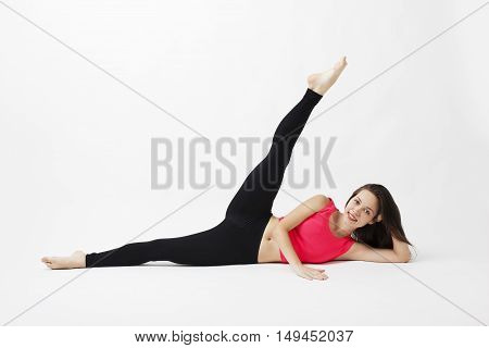 Attractive young woman working in a closed room. Beautiful model, doing exercises. Pilates