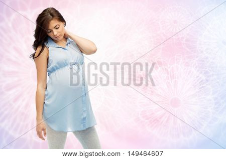 pregnancy, health, people and expectation concept - pregnant woman in bed touching her back and suffering from neckache over rose quartz and serenity pattern background